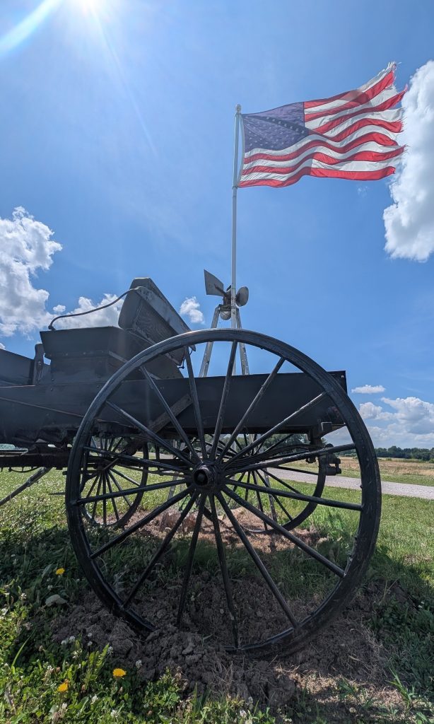 Historic cannon display with an American flag.